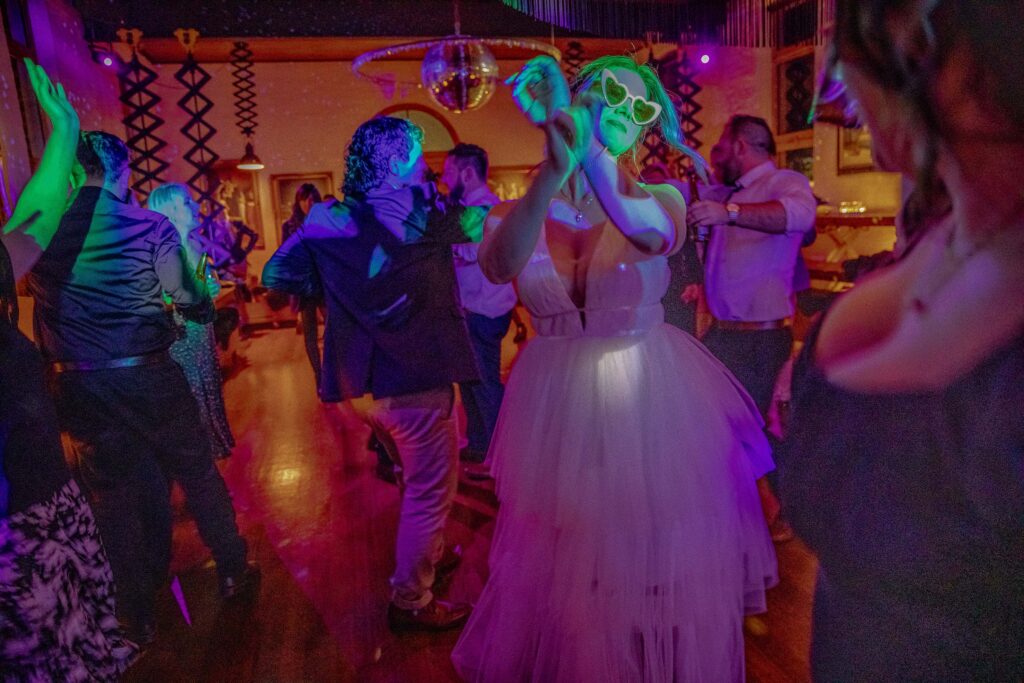 Bride dancing at reception having fun she was stress free after having a well planned wedding timeline