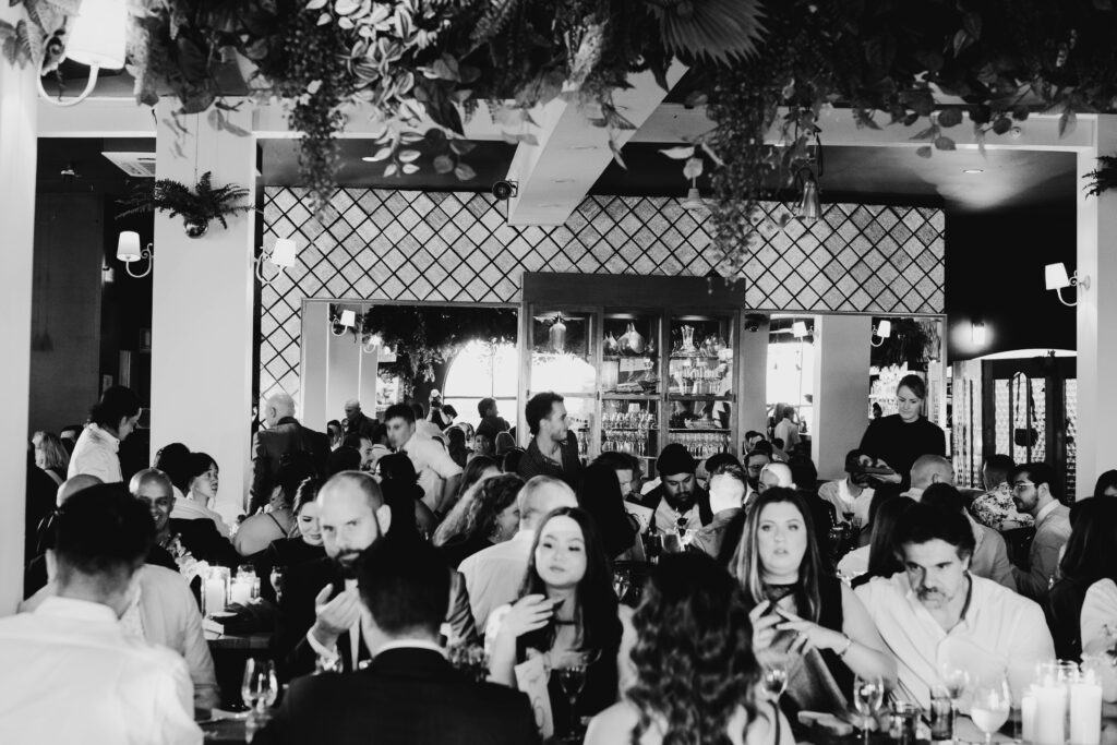 Black and white image of people eating at Panama Dining room in Fitzroy.