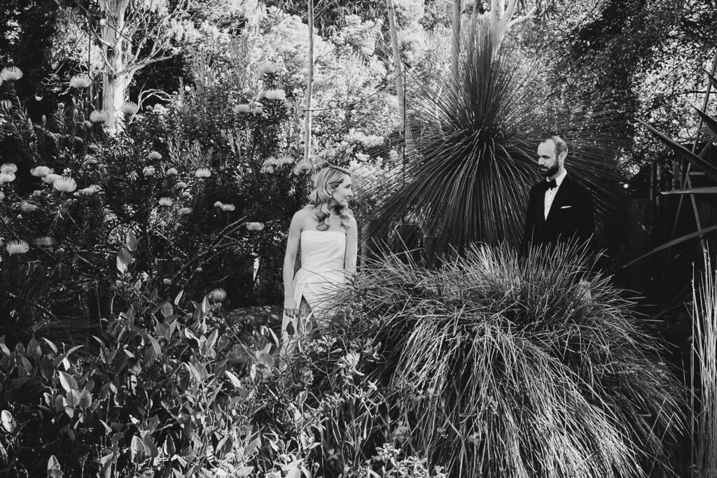 Bride and groom in the garden at Projekt 3488 having a wedding photo taken