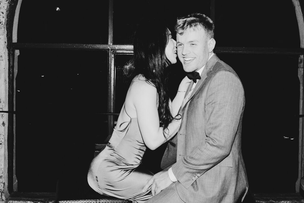 A couple at the Panama Dining room having wedding photos taken. It's black and white image they are having fun