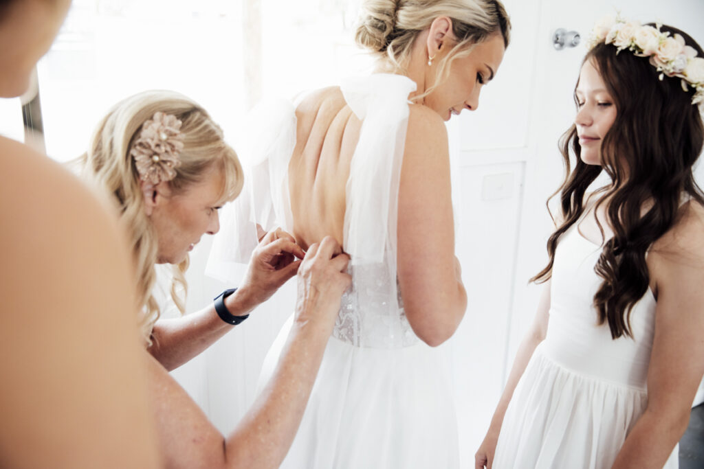 A colour image of a bride getting ready at Eight acres lakes entrance