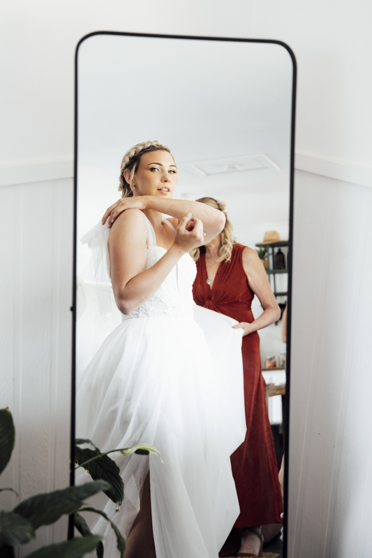 A colour image of a bride getting ready at Eight acres lakes entrance