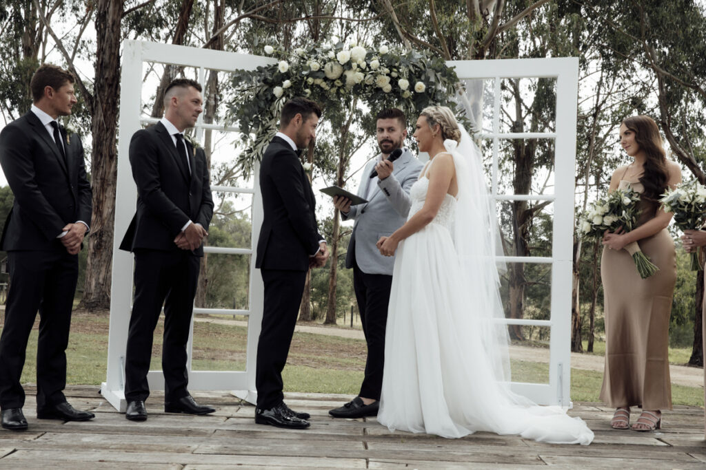 A Colour imaage of a bride and groom standing at the alter at Eight Acres in Lakes entrance getting married.