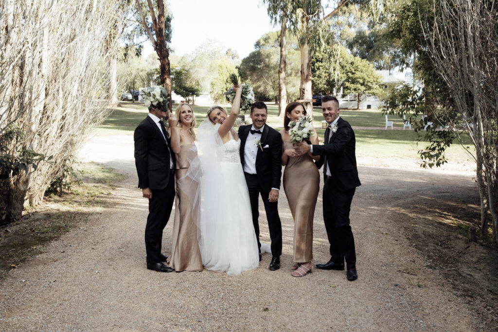 Bridal party having fun and laughing on a wedding day at Eight Acres in Lakes entrance.