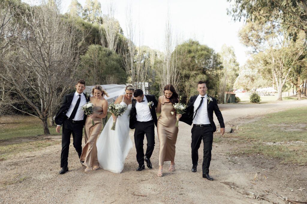 Bridal party having fun and laughing on a wedding day at Eight Acres in Lakes entrance.