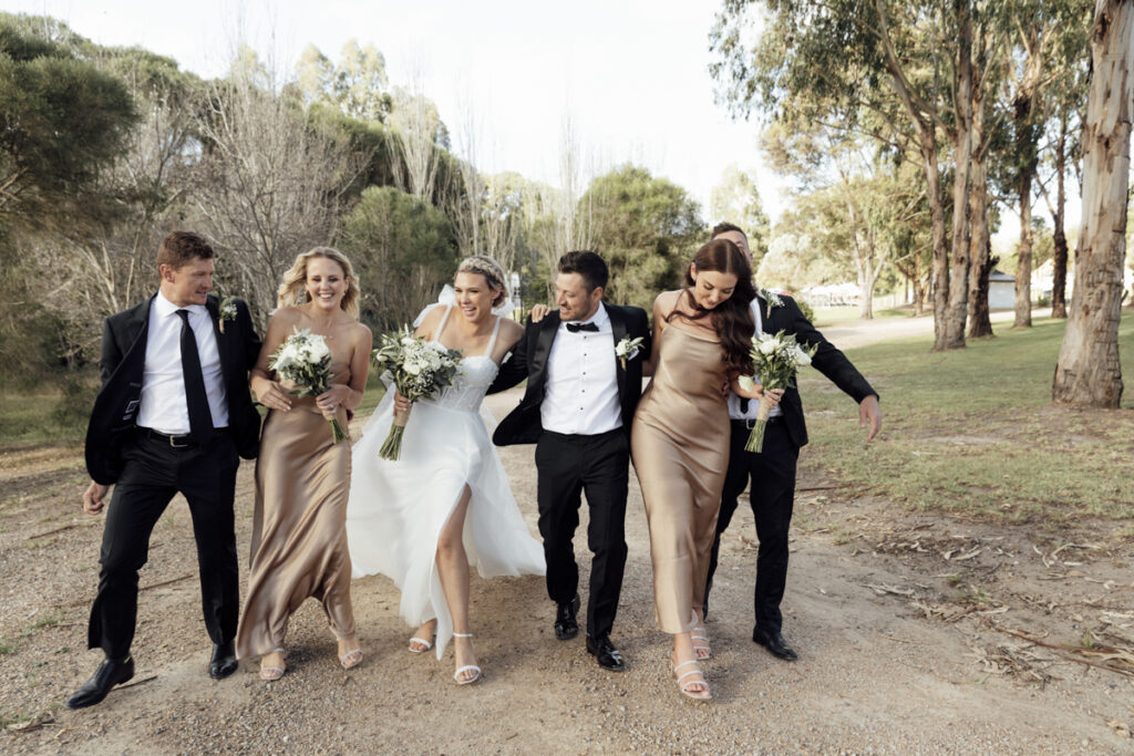 Bridal party having fun and laughing on a wedding day at Eight Acres in Lakes entrance.