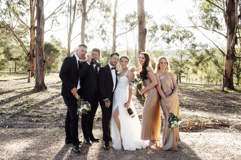 Bridal party having fun and laughing on a wedding day at Eight Acres in Lakes entrance.