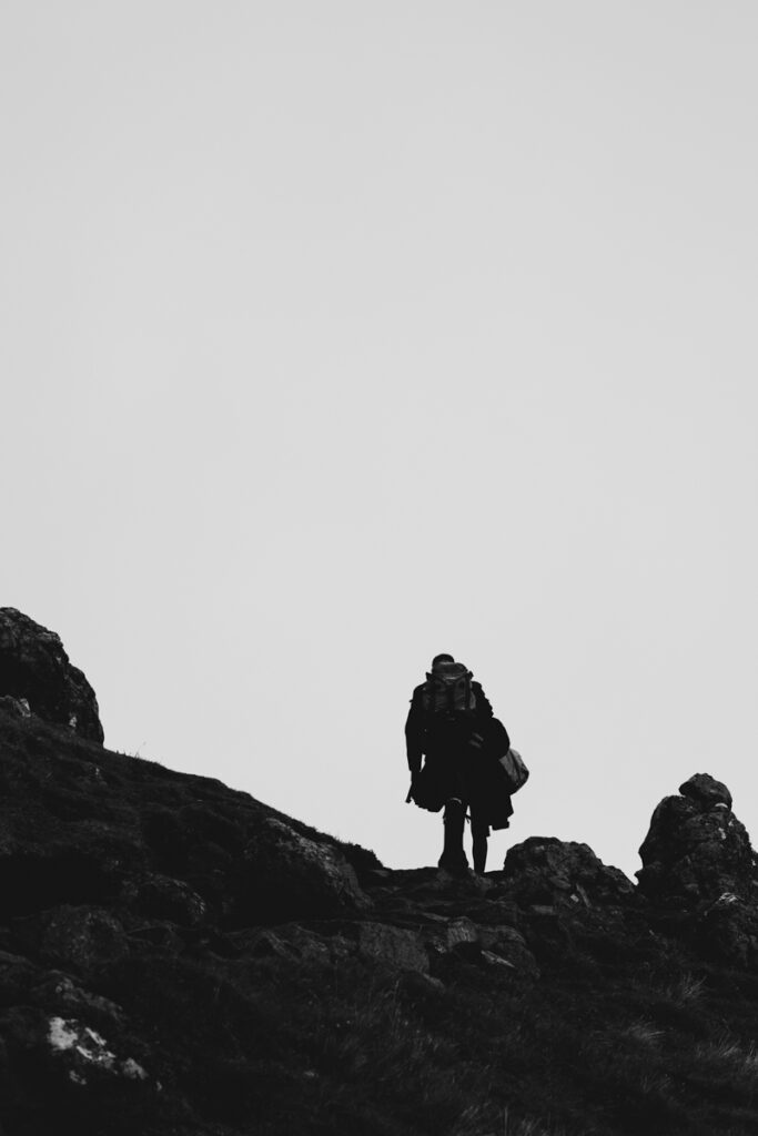 Embracing Adventure as a Scotland wedding photographer. A couple having Black and white wedding photos as they elope up Old man of Storr in Skye