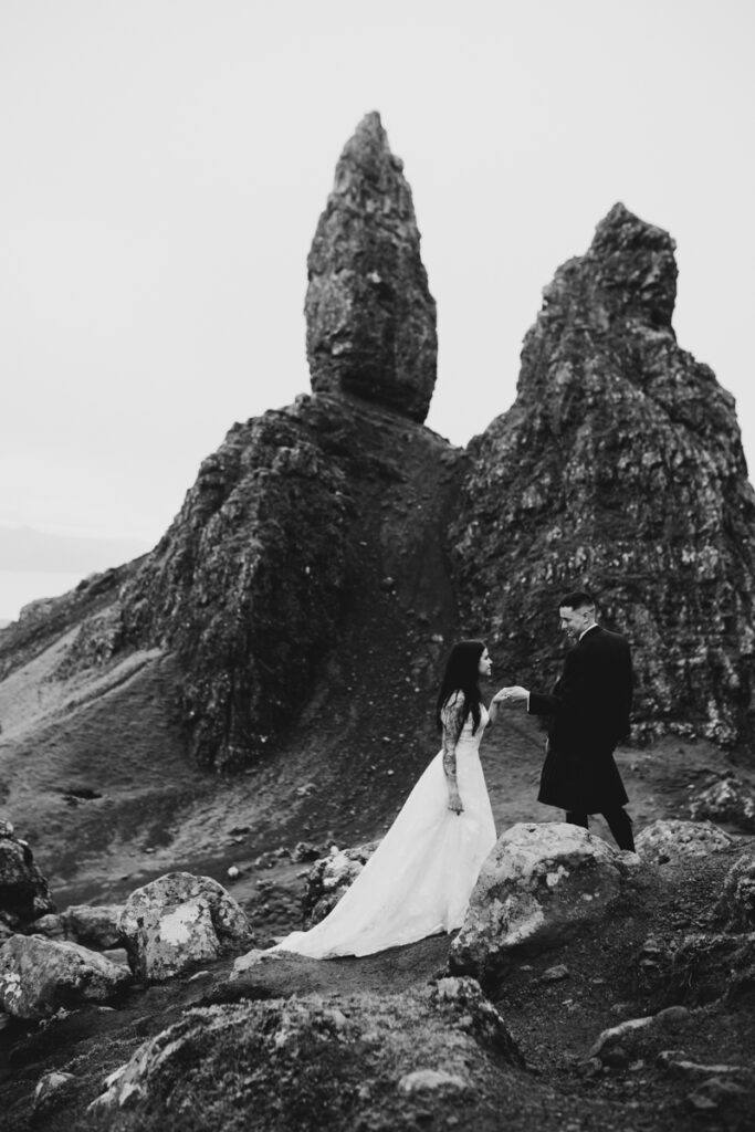Embracing Adventure as a Scotland wedding photographer. A couple having Black and white wedding photos as they elope up Old man of Storr in Skye