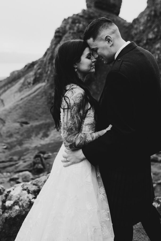 Embracing Adventure as a Scotland wedding photographer. A couple having Black and white wedding photos as they elope up Old man of Storr in Skye