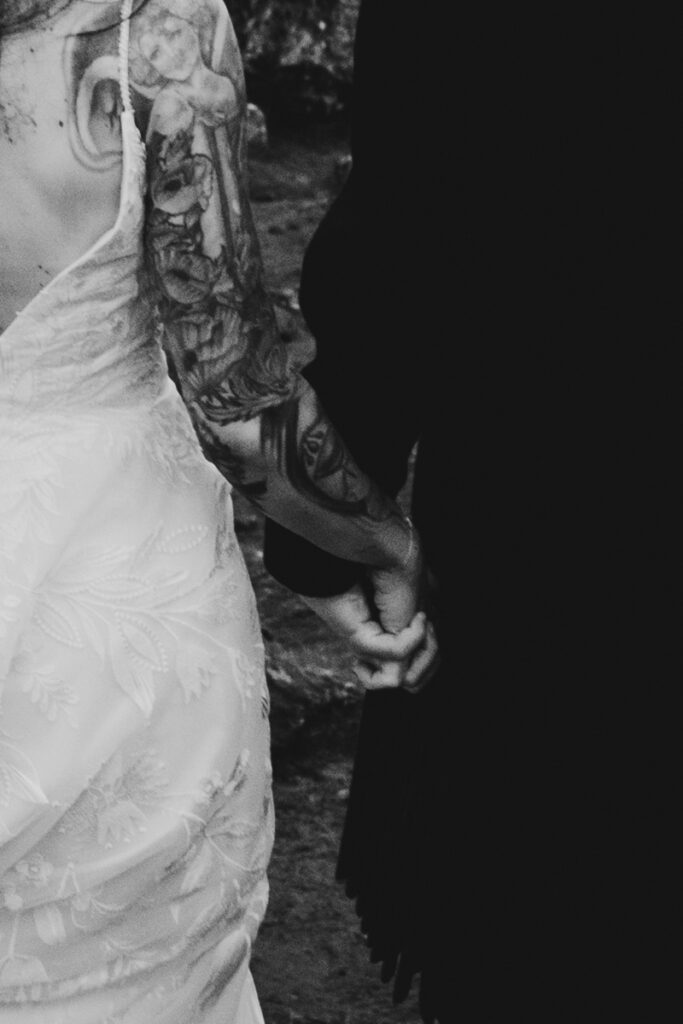 Embracing Adventure as a Scotland wedding photographer. A couple having Black and white wedding photos as they elope up Old man of Storr in Skye