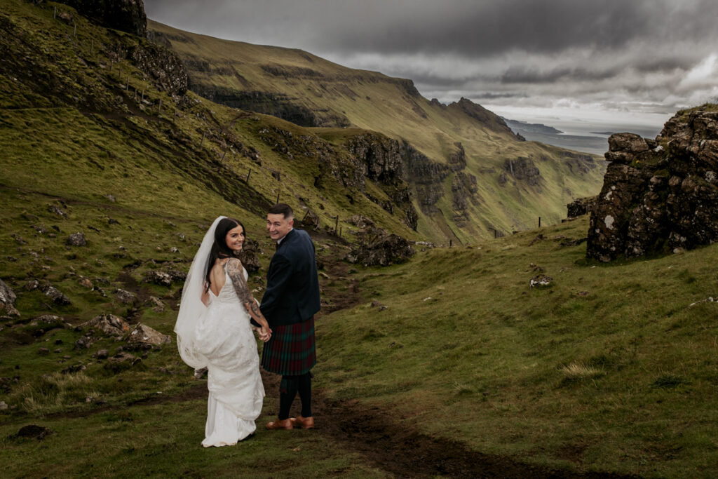 Scotland wedding photographer - a couple having wedding photos on the Old man of Storr
