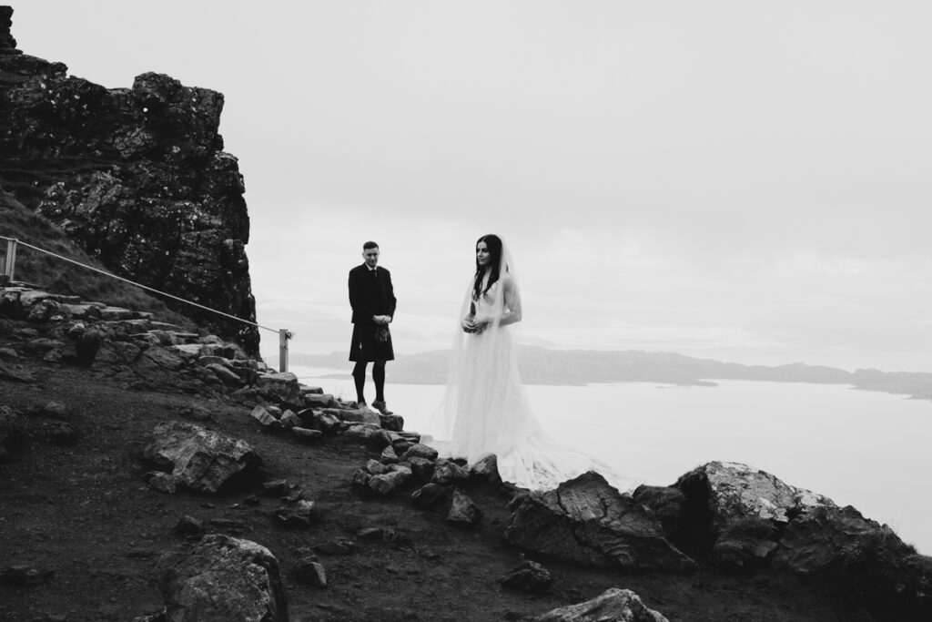 Embracing Adventure as a Scotland wedding photographer. A couple having Black and white wedding photos as they elope up Old man of Storr in Skye