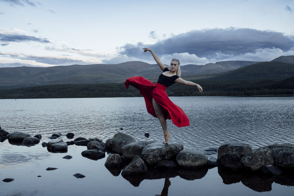 Scotland wedding photographer - a girl having a photo at Loch Morlich in Scotland