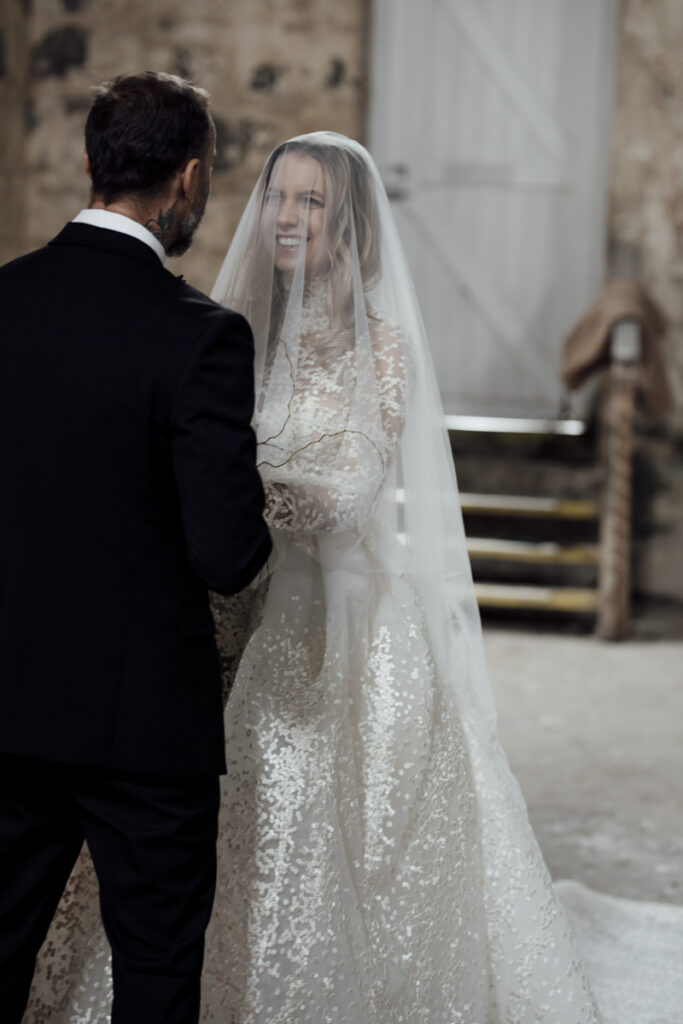 Provenance wedding photography. A couple having their wedding photos taken in Provenance in the grand Hall, that are happy and laughing.