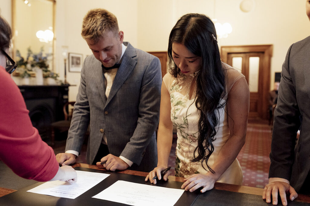 Victorian Marriage Registry- a photo of a couple signing their marriage cert