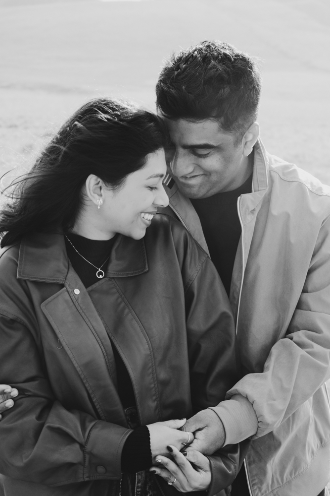 Pre-wedding photoshoot Melbourne in Flinders a couple laughing and hugging
