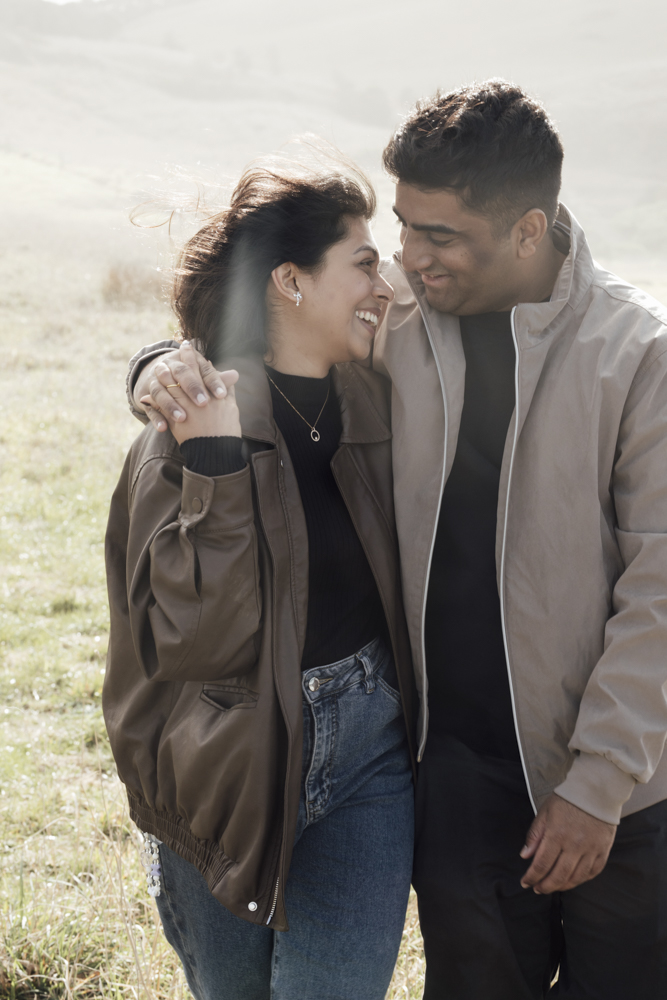 Pre-wedding photoshoot Melbourne in Flinders a couple laughing and hugging