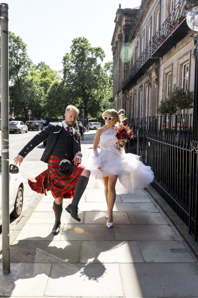 Edinburgh wedding photographer candid, a bride and groom having wedding photos taken on the streets of Edinburgh