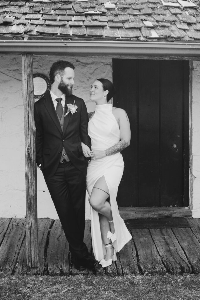 black and white image, bride and groom standing in a door way at Emu Bottom Homestead. Macedon Ranges wedding photography. Sunbury wedding photographer