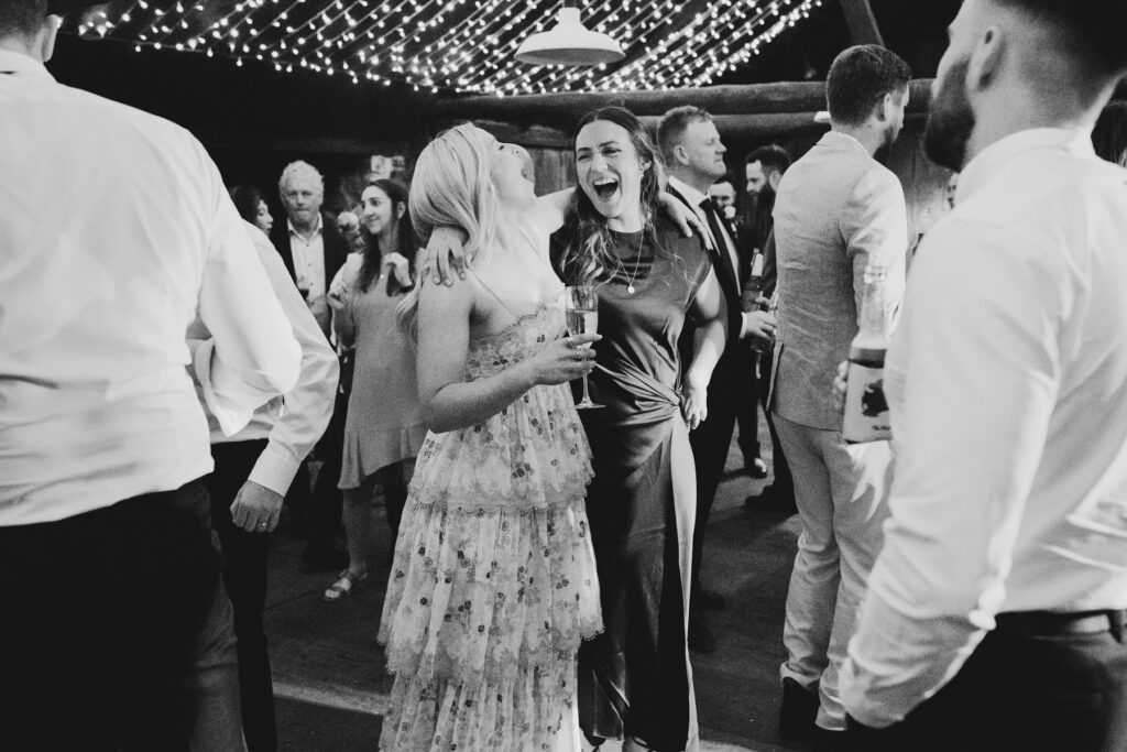 Emu Bottom Homestead wedding photography. Macedon Ranges Wedding photographer. a wedding reception the woolshed at Emu bottom homestead. Guests dancing.