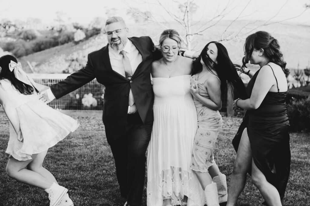 Warrawong estate wedding. Macedon Ranges Wedding photographer. Bride and Groom standing at alter laughing