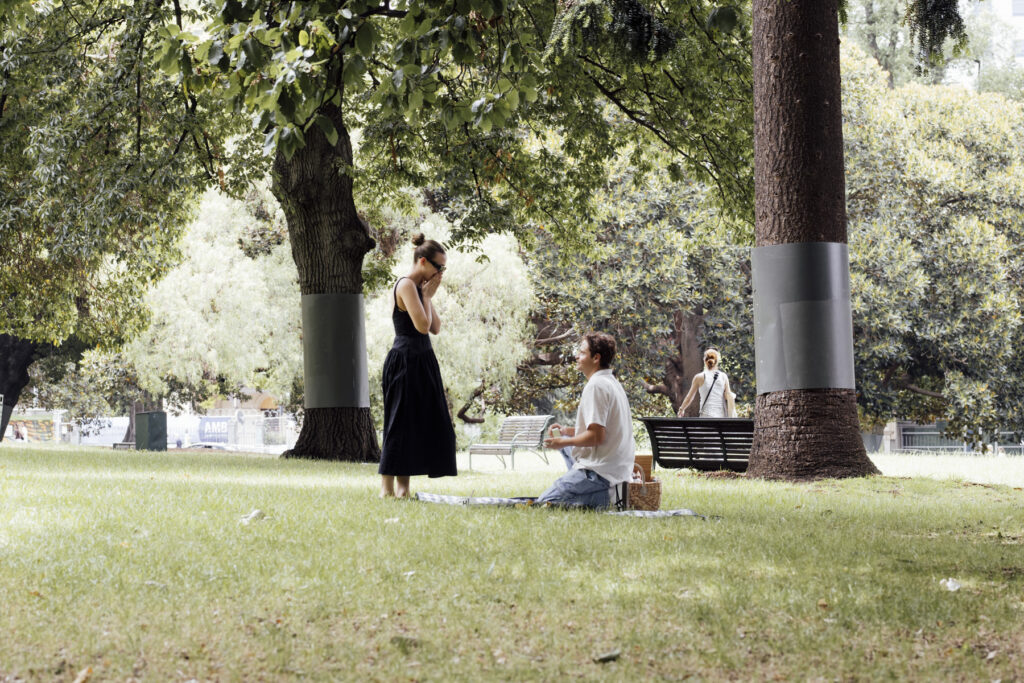 Carlton Gardens proposal. Melbourne Proposal photography. A Proposal in Melbourne. Proposal Photographer. Engagement photographer in Melbourne. a Young couple laughing and holding hands. Candid Documentary Photography 