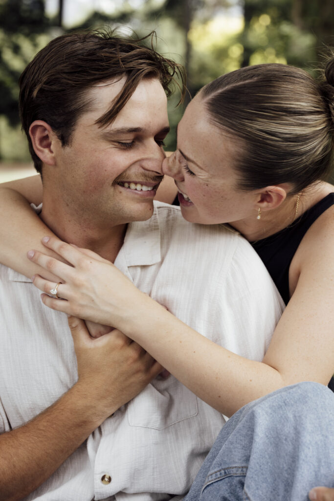 Carlton Gardens proposal. Melbourne Proposal photography. A Proposal in Melbourne. Proposal Photographer. Engagement photographer in Melbourne. a Young couple laughing and holding hands. Candid Documentary Photography 