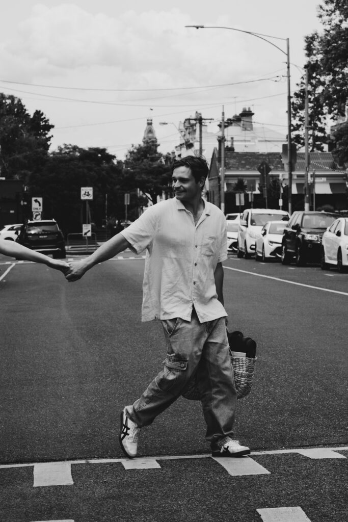 Carlton Gardens proposal. Melbourne Proposal photography. A Proposal in Melbourne. Proposal Photographer. Engagement photographer in Melbourne. a Young couple laughing and holding hands. Candid Documentary Photography 