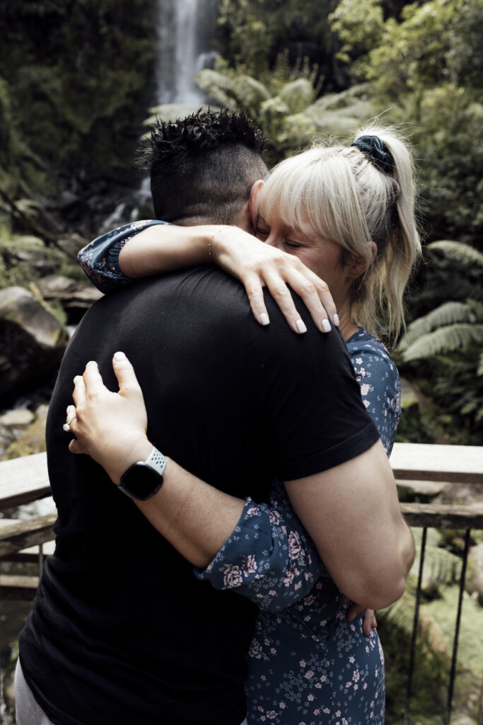 Melbourne Proposal Photography a young fun couple hugging at Erskine Falls on Great Ocean road