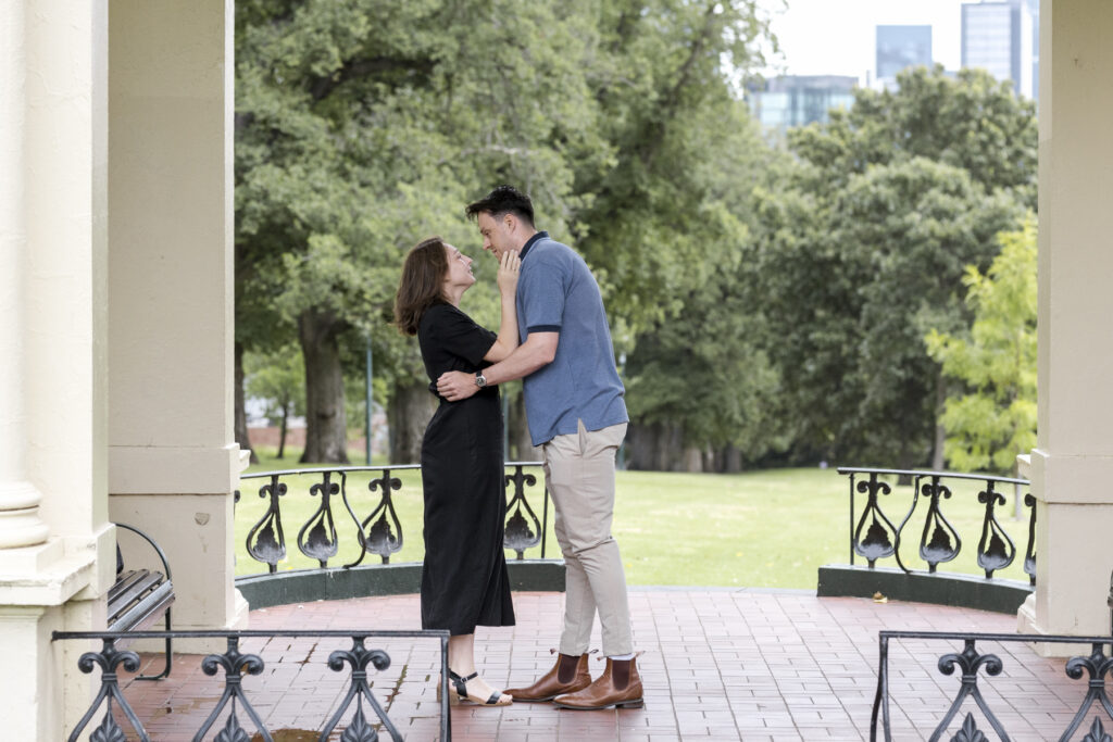 Fitzroy gardens proposal. Melbourne Proposal photography. A Proposal in Melbourne. Proposal Photographer. Engagement photographer in Melbourne. a Young couple laughing and holding hands. Candid Documentary Photography 