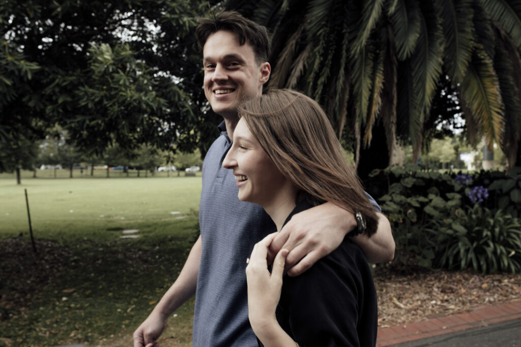 Fitzroy gardens proposal. Melbourne Proposal photography. A Proposal in Melbourne. Proposal Photographer. Engagement photographer in Melbourne. a Young couple laughing and holding hands. Candid Documentary Photography 