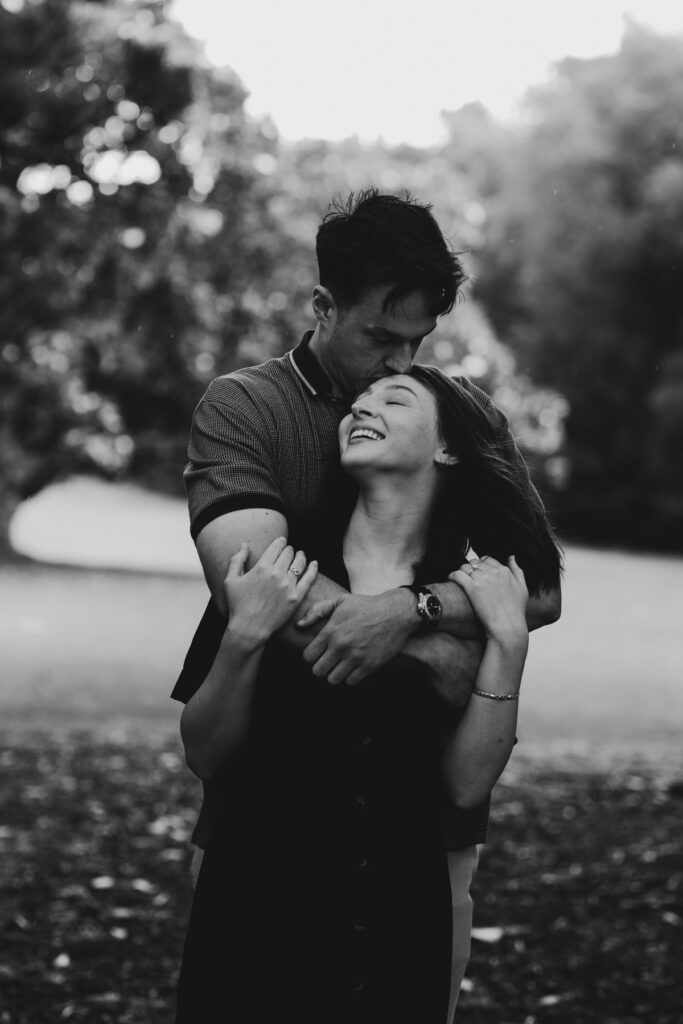 Fitzroy gardens proposal. Melbourne Proposal photography. A Proposal in Melbourne. Proposal Photographer. Engagement photographer in Melbourne. a Young couple laughing and holding hands. Candid Documentary Photography 
