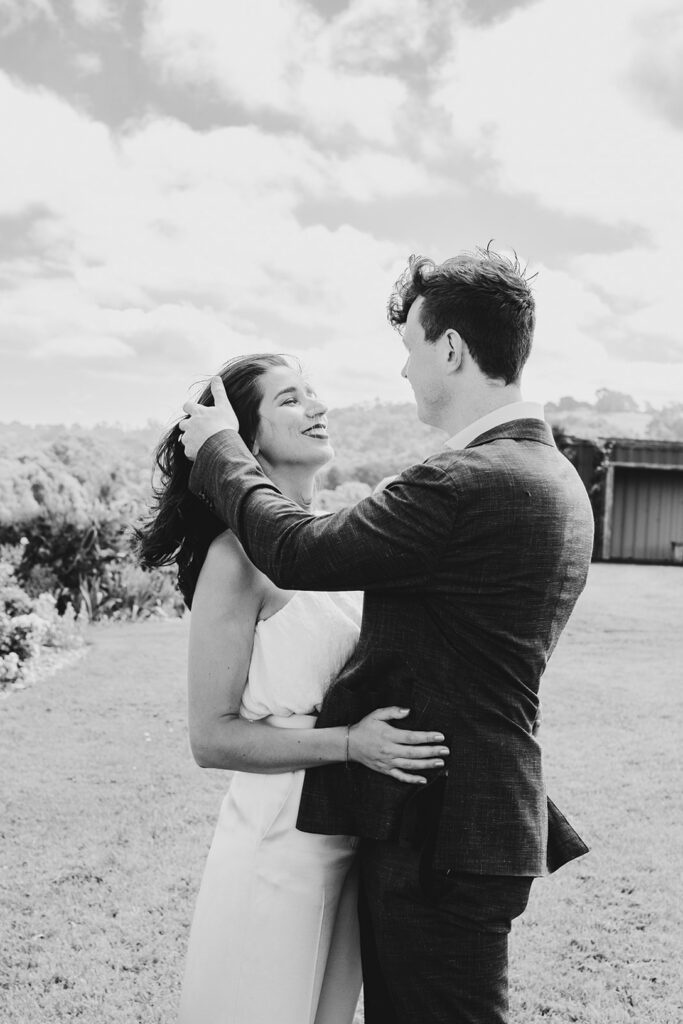 Black and white motion image of a couple at Gurneys' Cider dancing, embracing spinning.