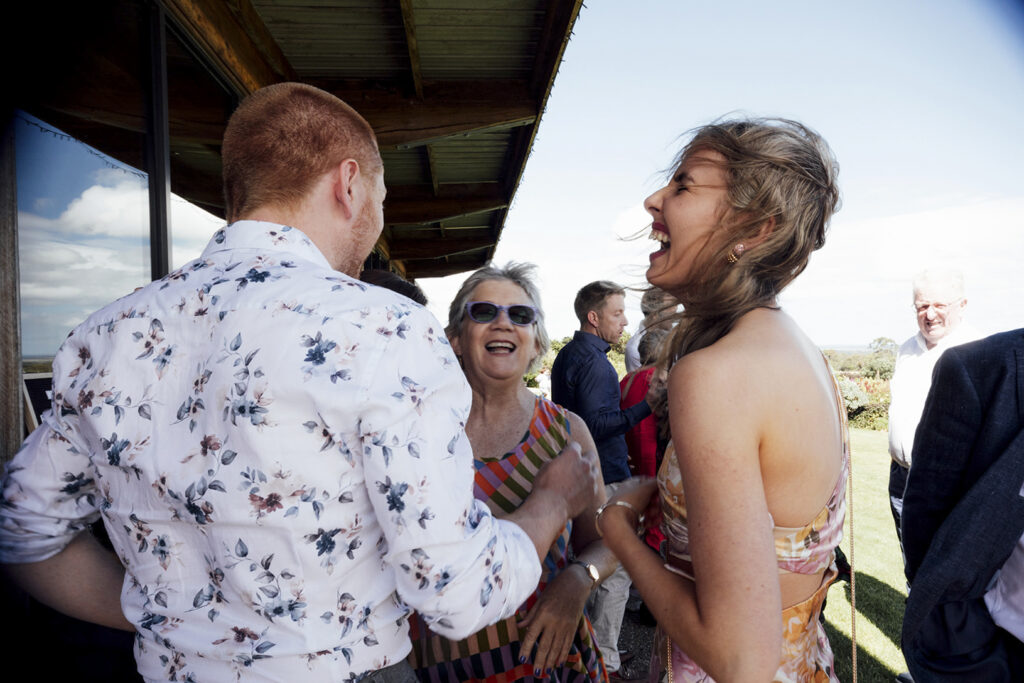 A wedding reception at Gurneys' cider people are laughing and dancing.