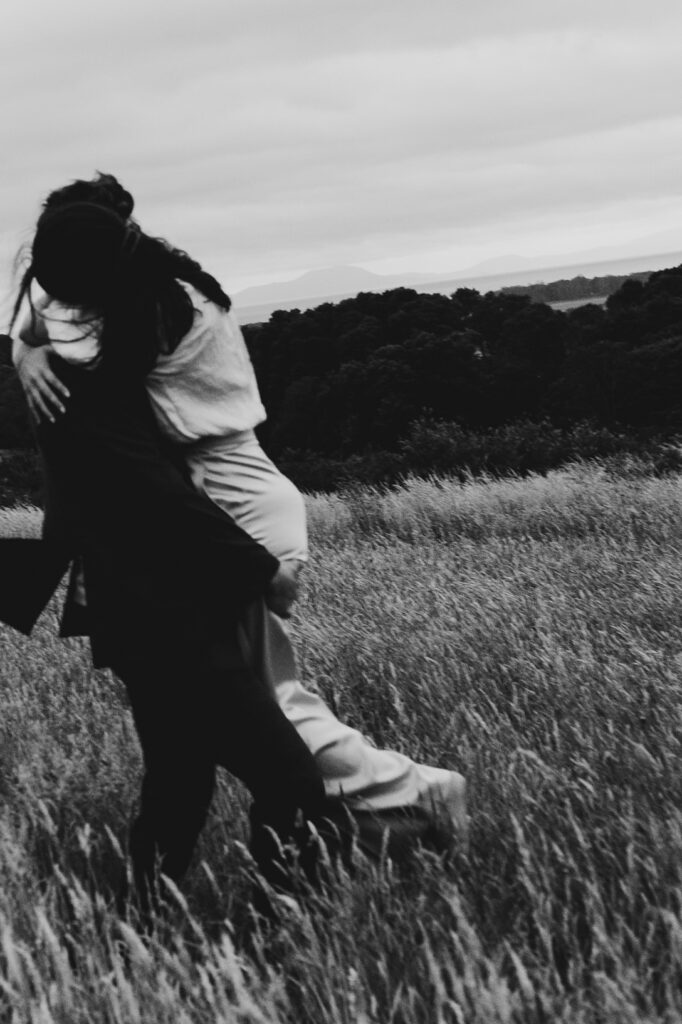 Black and white motion image of a couple at Gurneys' Cider, dancing, embracing spinning.