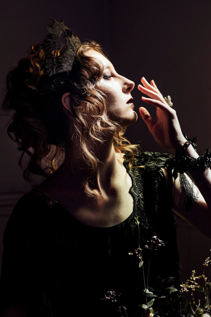 a bride standing in the bluestone chapel at Scrub Hill on her wedding day, she is an alternive bride wearing a stunning black dress from Gwendolyn in Melbourne. She is more moody and alternative.