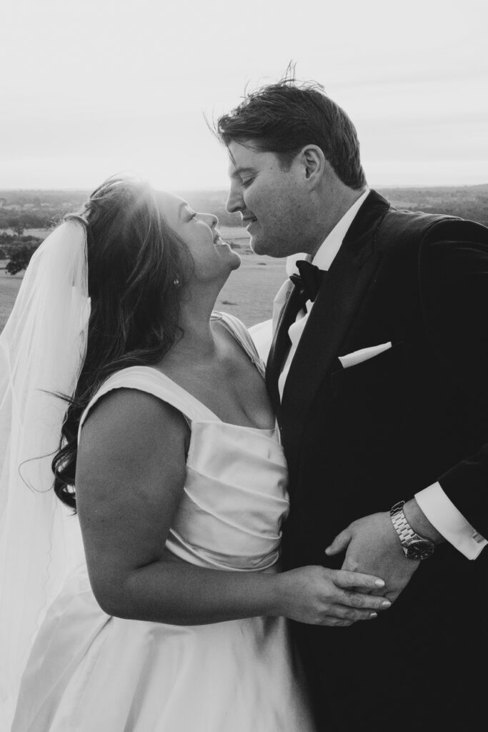A black and white image of a bride and groom having wedding photos taken at Paramoor Winery in Macedon Ranges.
