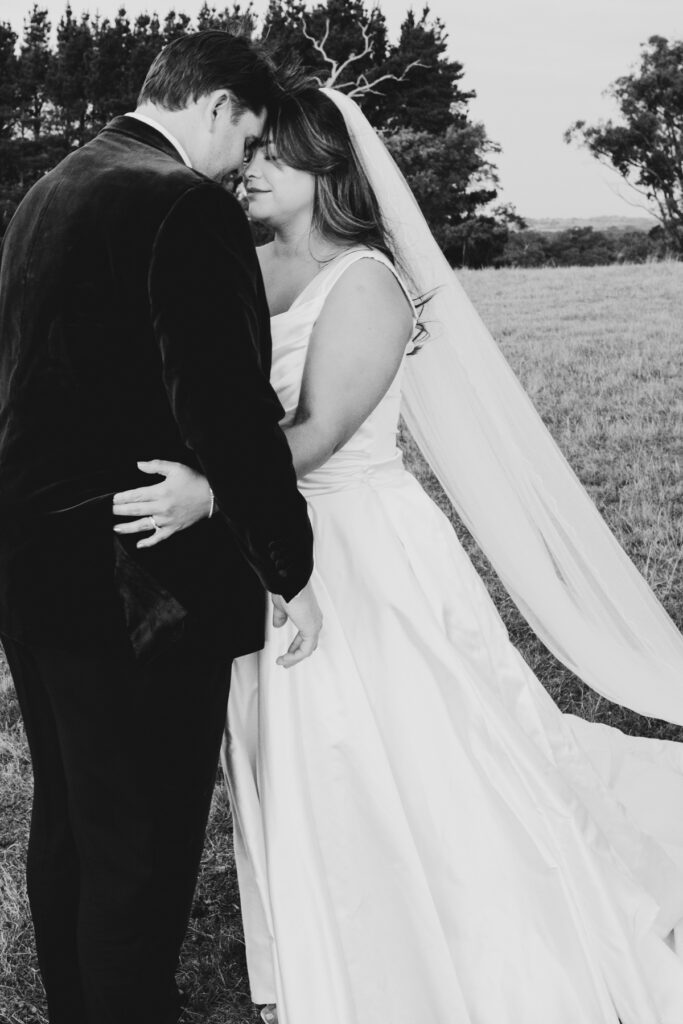 A black and white image of a bride and groom having wedding photos taken at Paramoor Winery in Macedon Ranges.