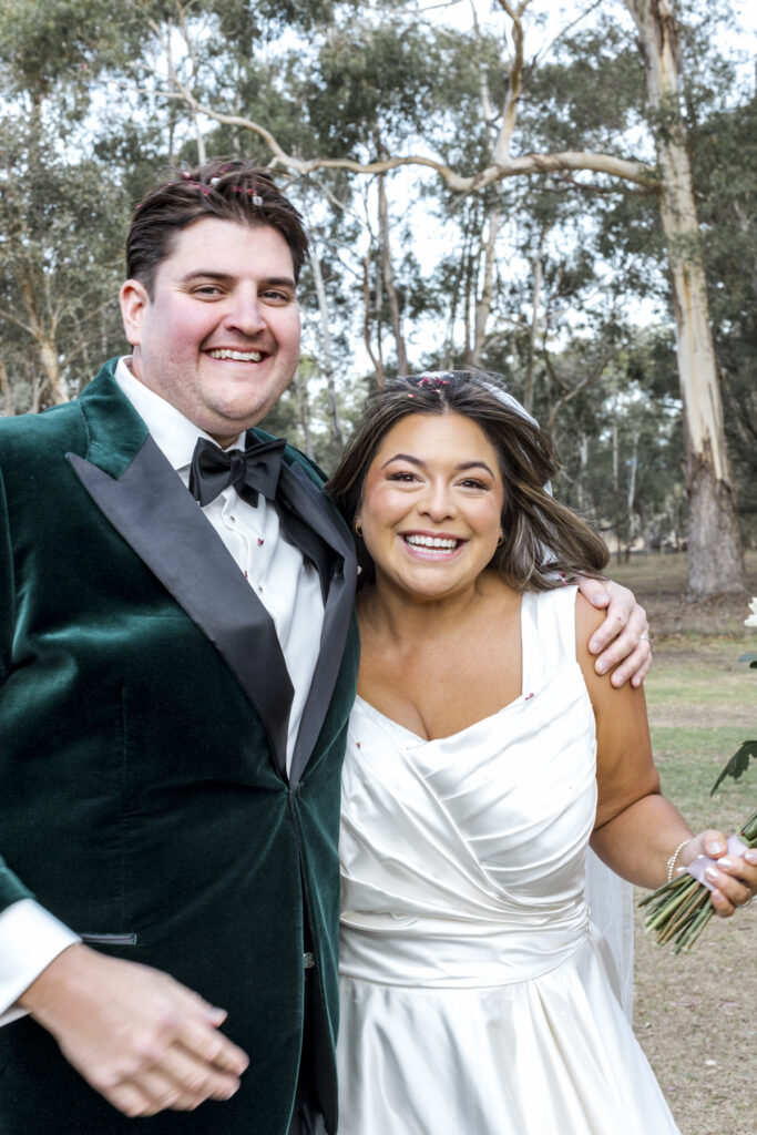 a bride and groom at Paramoor Winery on their wedding day. The bride and groom are smiling and laughing