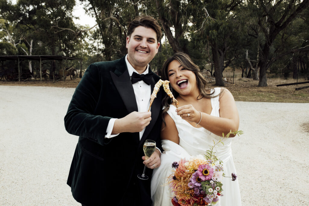 a bride and groom at Paramoor Winery on their wedding day. The bride and groom are smiling and laughing