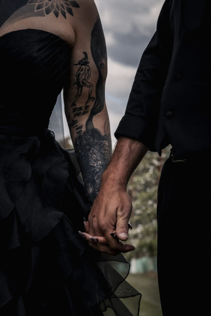 a close up image of hands and tattoos on an alternative wedding day. The wedding is at DV cider.