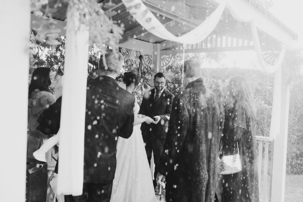 What to do if it rains on your wedding day? a beautiful rainy black and white photo of a rainy ceremony